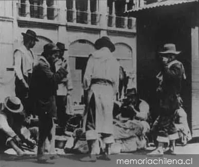 Carretoneros almorzando en la calle, 1906 — 1906 | Chile de Ayer