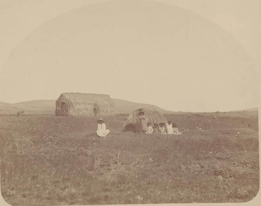 Group in Costume Outside Thatch House with Large Haystack In Background 1886 — Isla de Pascua — 1886 | Chile de Ayer